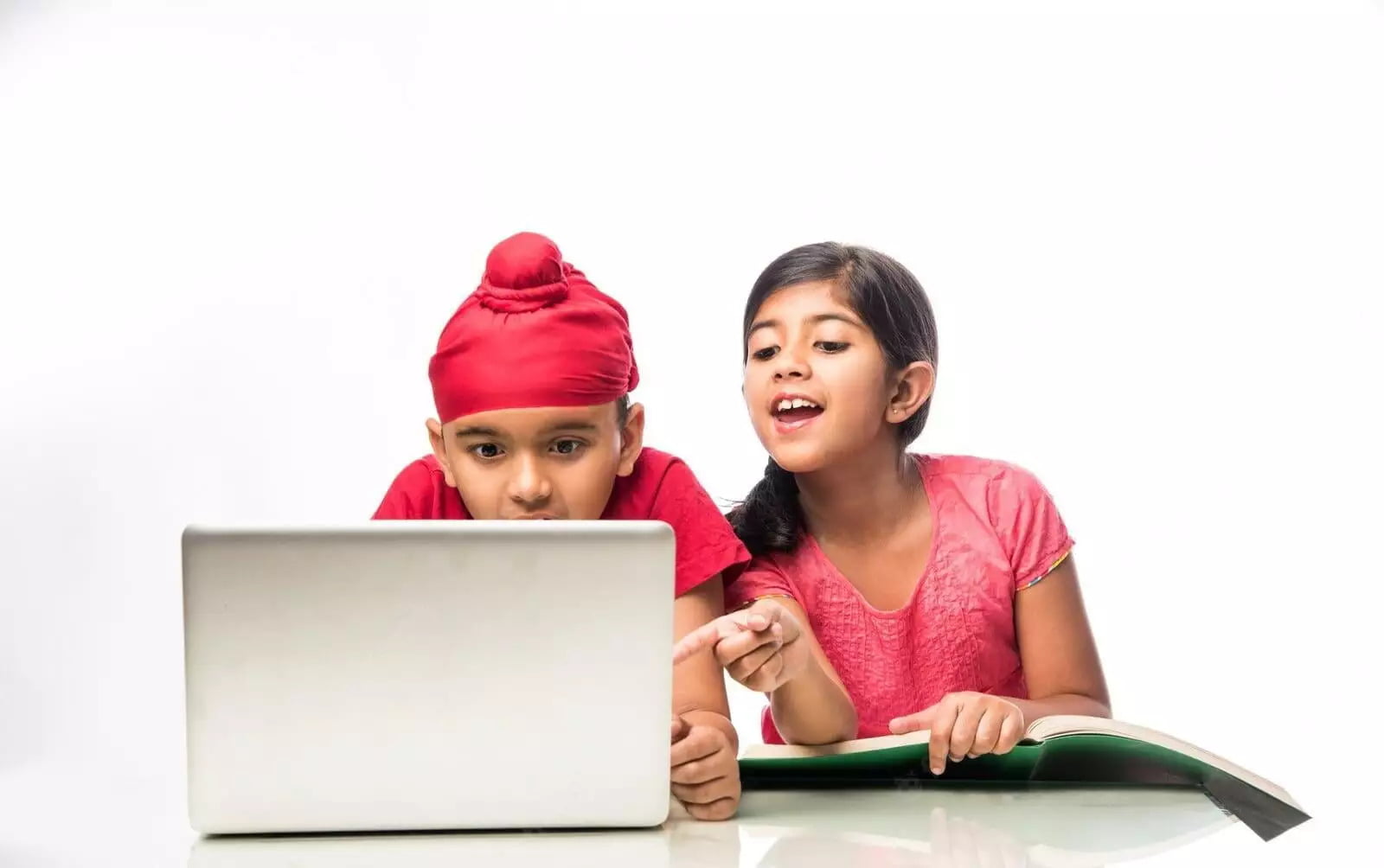 Indian kids sitting in a classroom, using laptops to learn typing skills. They are focused and engaged in their typing lessons.
